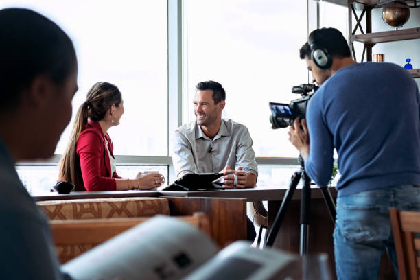 corporate crew filming executive interview in office
