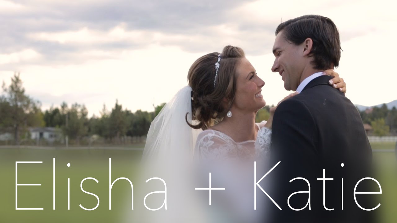 bride and groom watching their wedding highlight film on a laptop