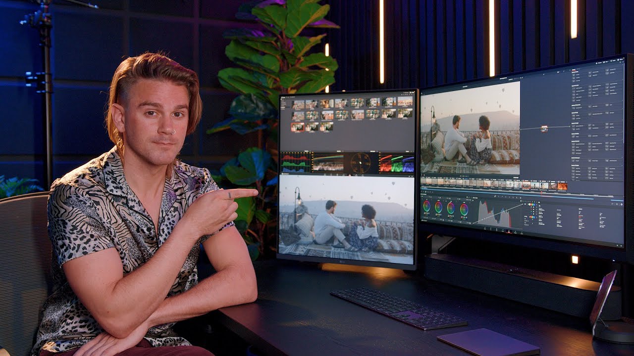 editor color grading interview footage on dual monitors