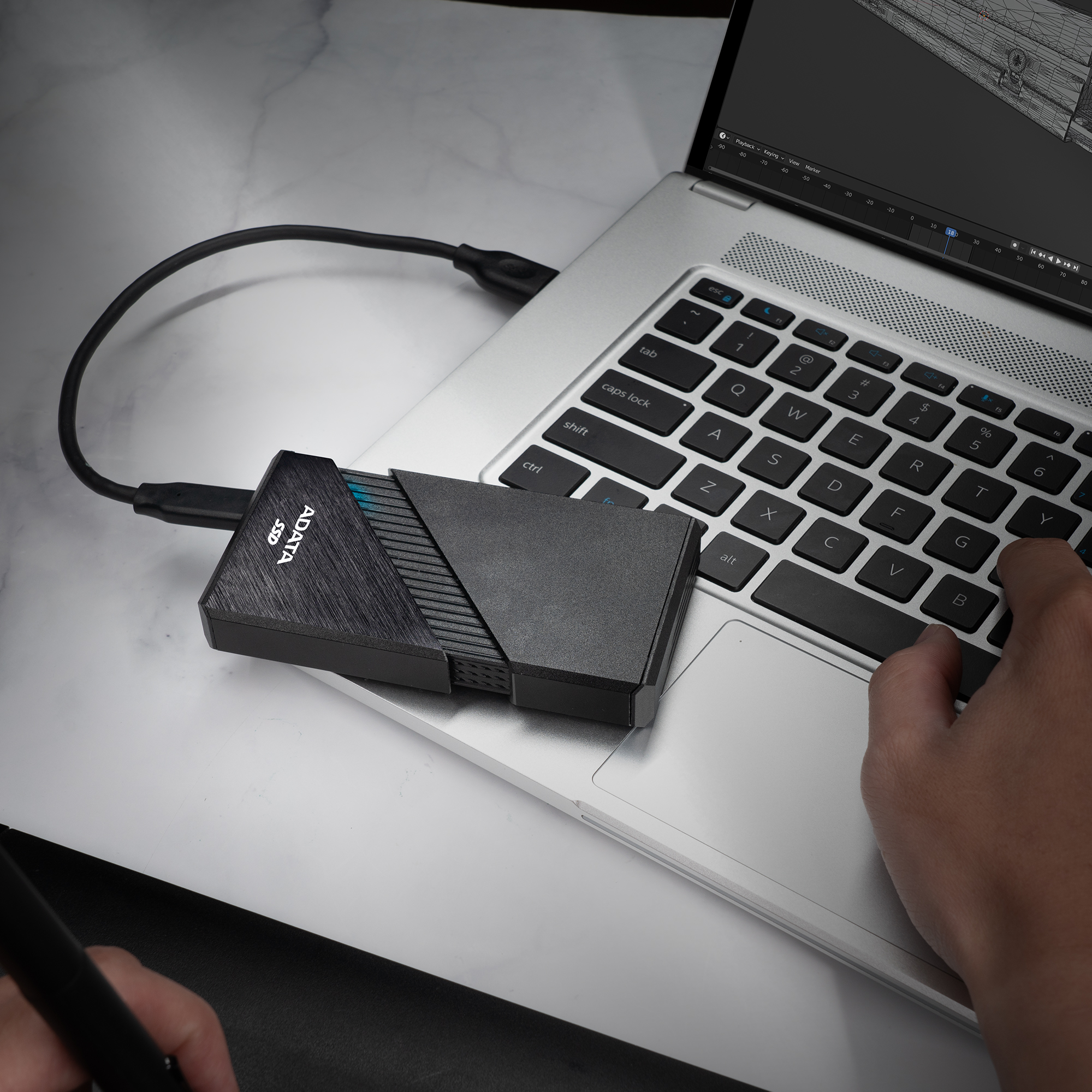 editor scrubbing 4K timeline beside external SSD drives
