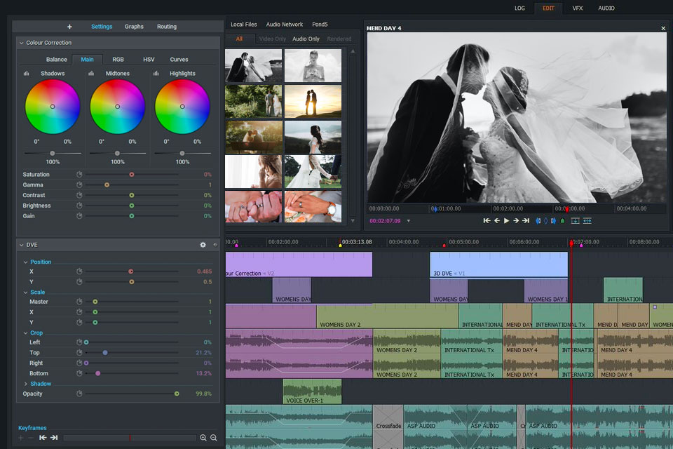 videographer editing wedding footage on computer with color grading