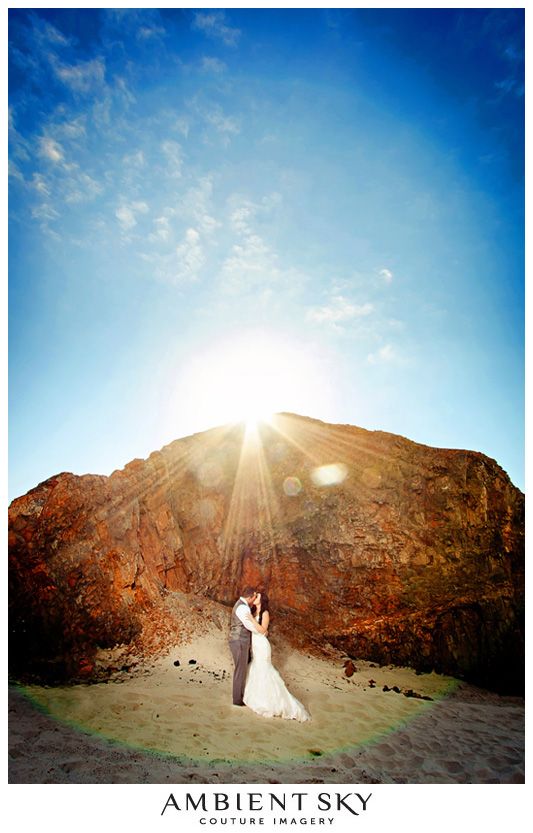 videographer filming wedding couple on a beach at sunset