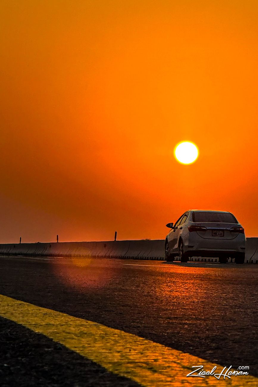 car driving open highway at golden hour
