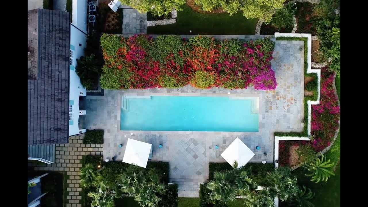 drone filming luxury home pool at golden hour