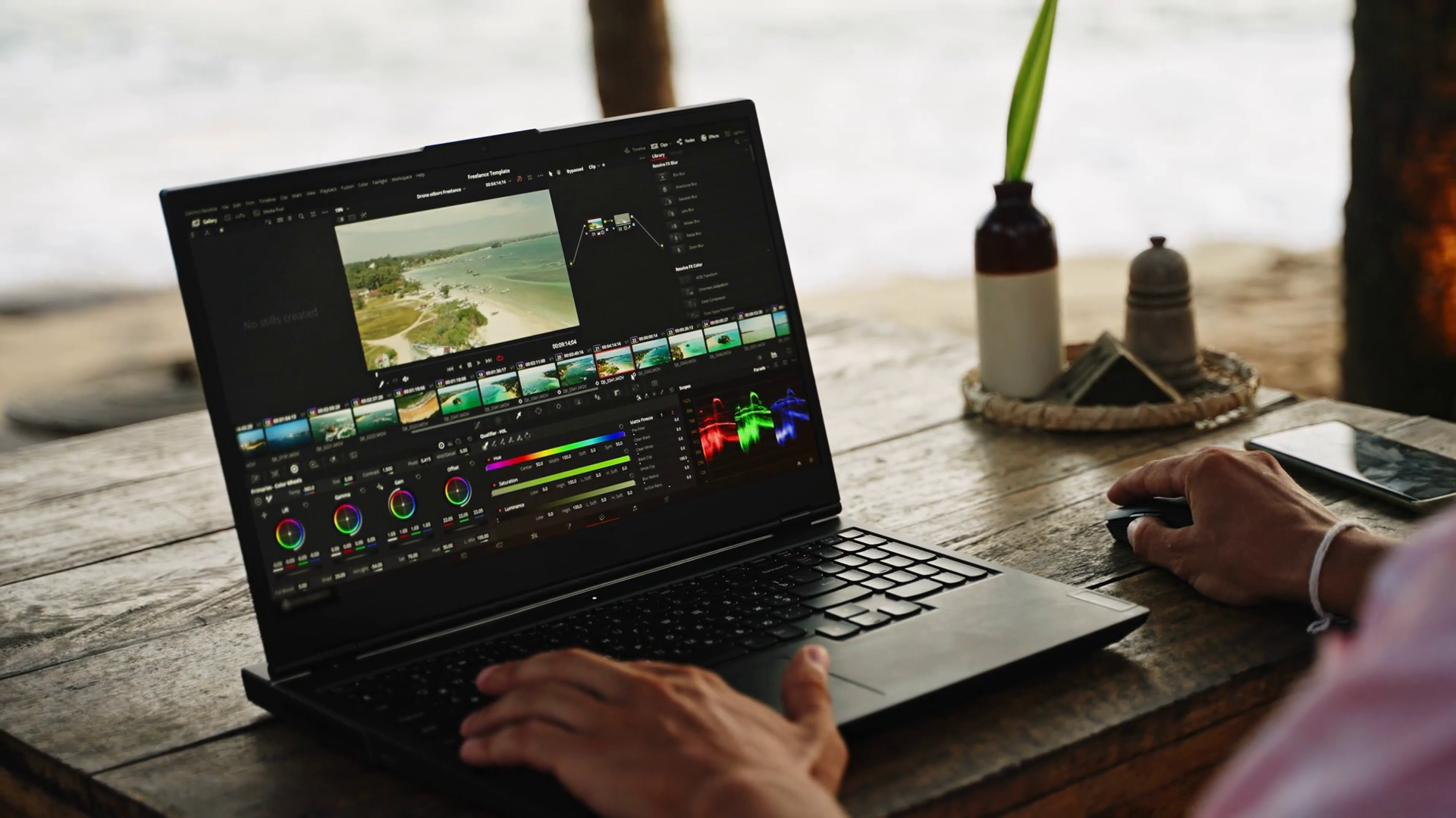 editor color grading commercial footage laptop