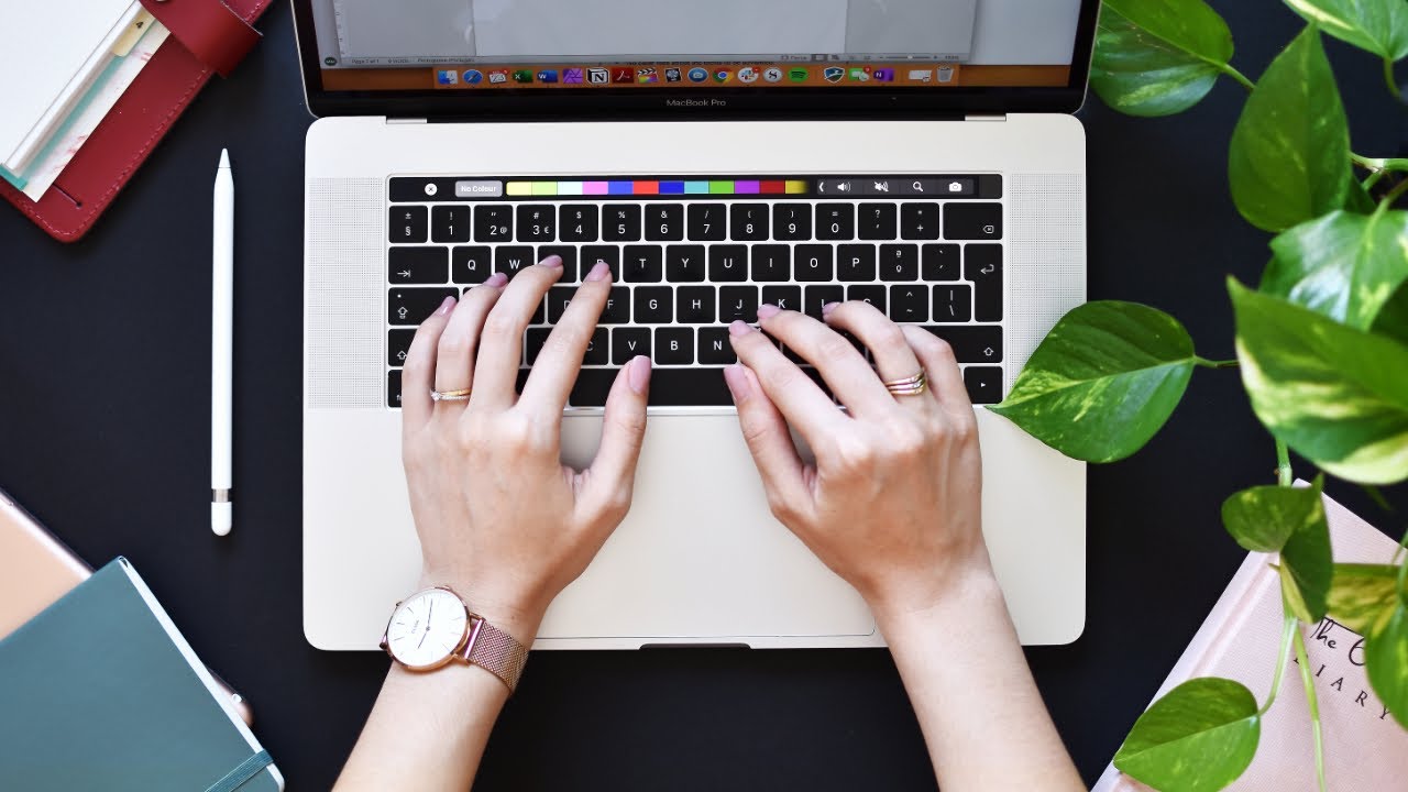 person writing video brief notes on laptop