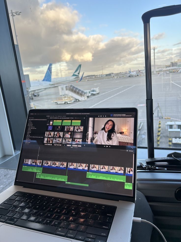 videographer editing travel footage on hotel room laptop