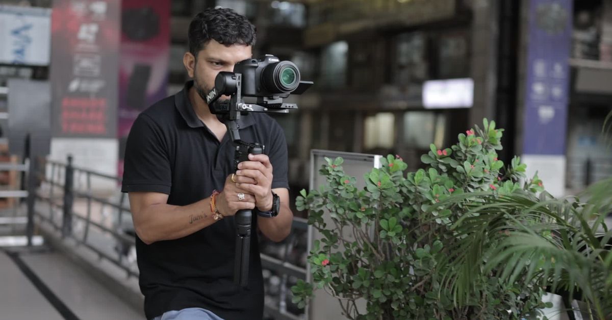 videographer filming product with gimbal in office