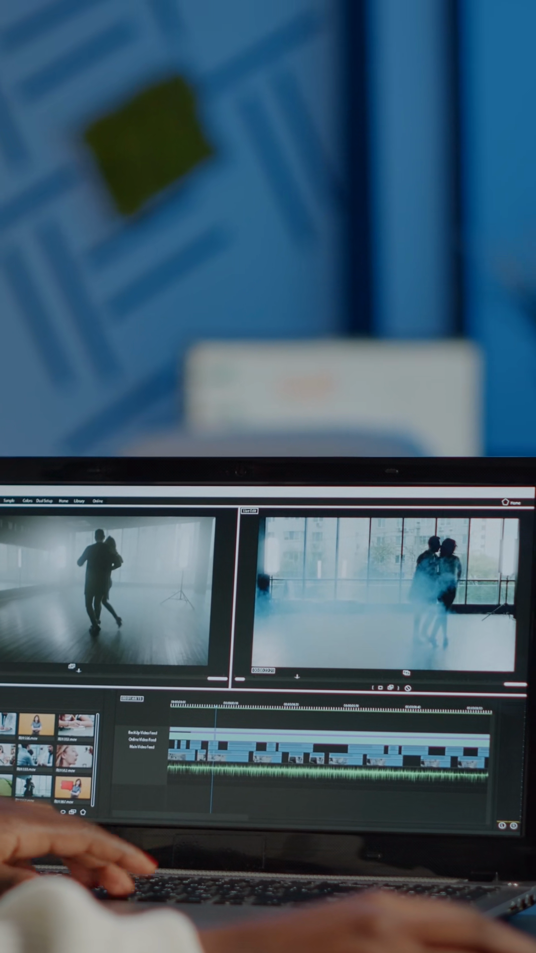 videographer reviewing footage on laptop under deadline