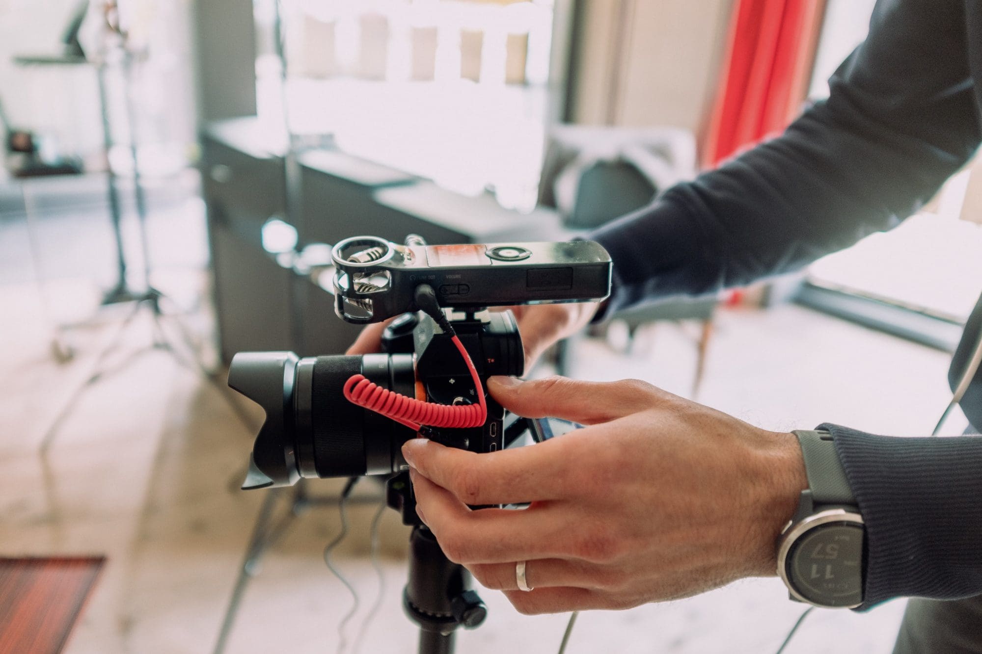 videographer setting up cinema camera on tripod