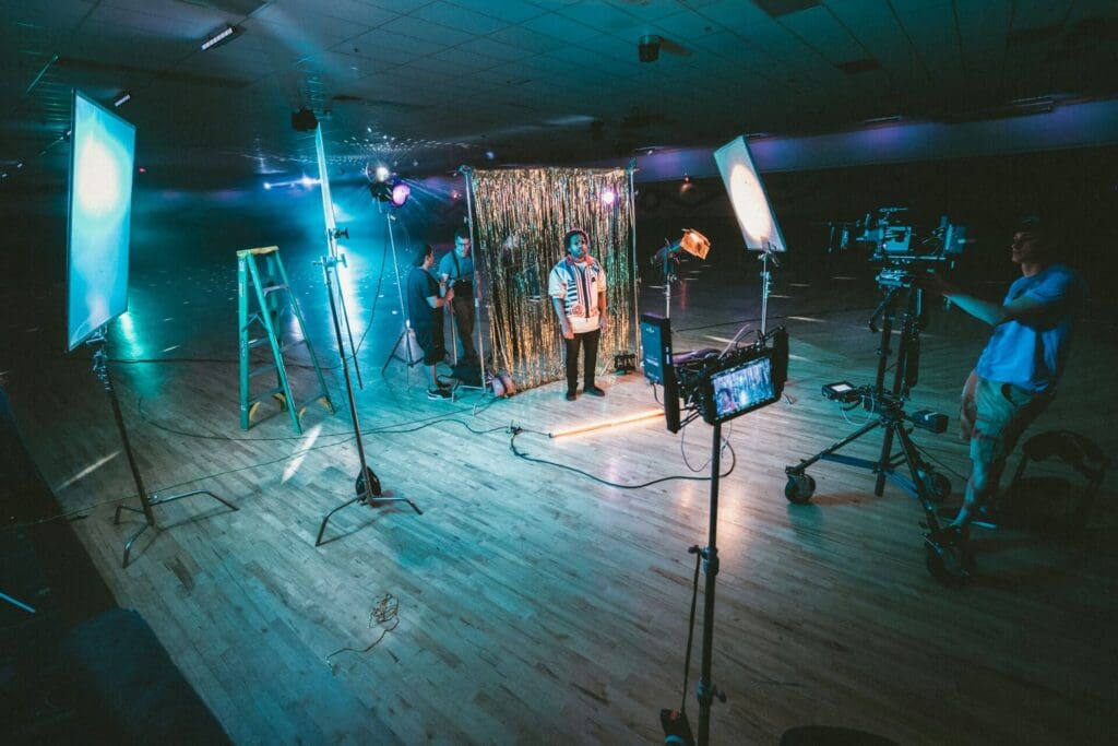 gaffer rigging lights on music video set