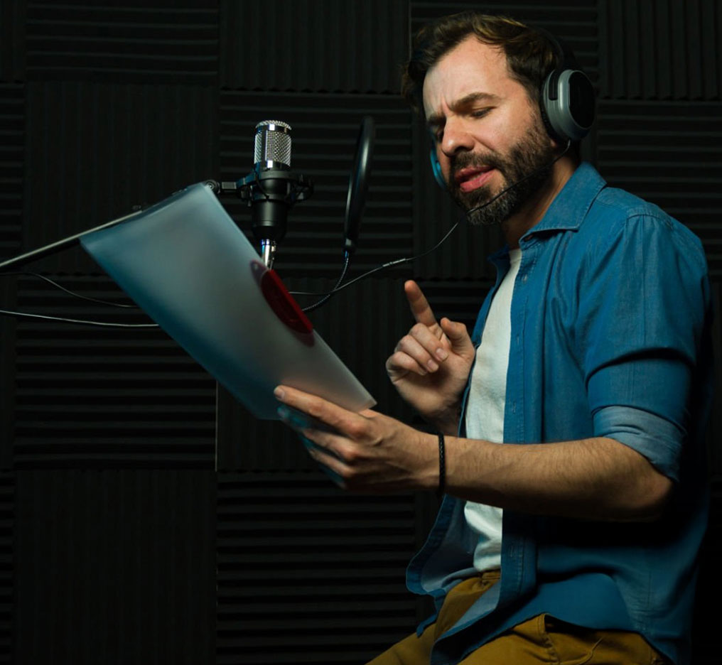 voice actor recording narration in isolation booth